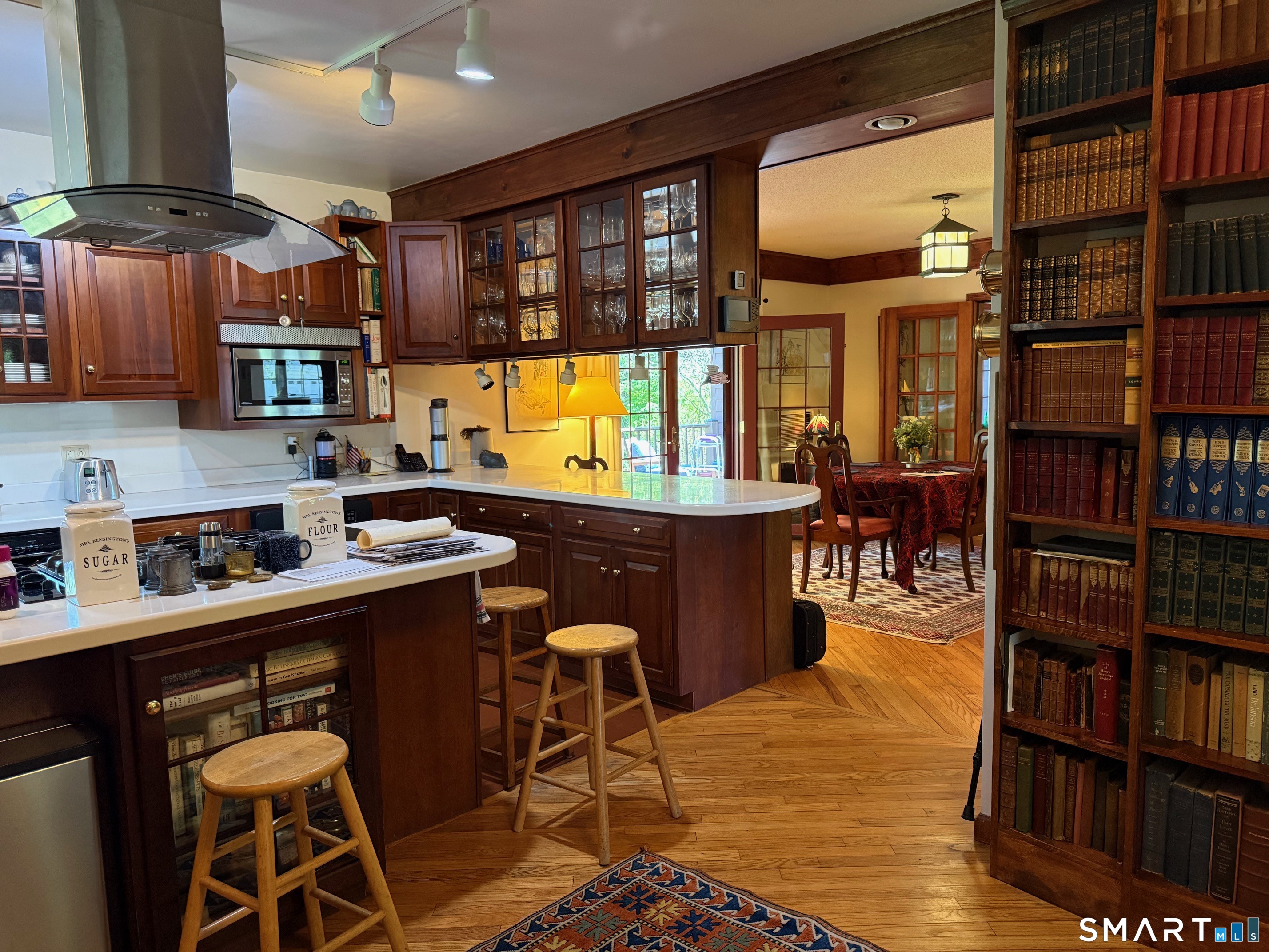 8 Ivy Road Stonington, CT 06355 - Photo 15 of 30 a room with stainless steel appliances kitchen island granite countertop a table chairs and a book shelf