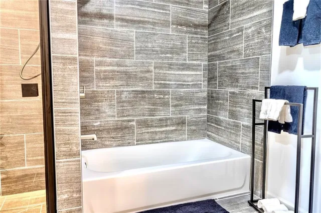 a bathroom with a bathtub and shower