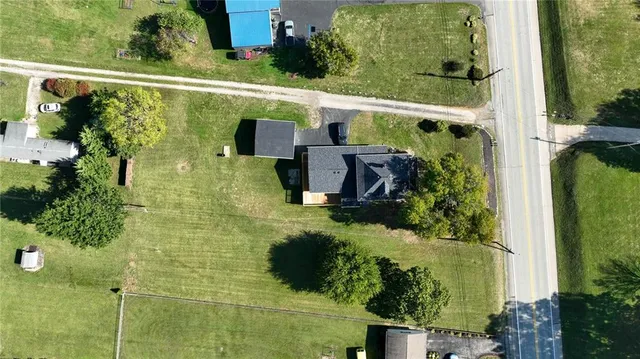 an aerial view of a house with a yard