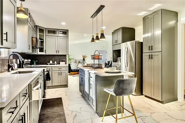 a kitchen with a sink appliances and cabinets