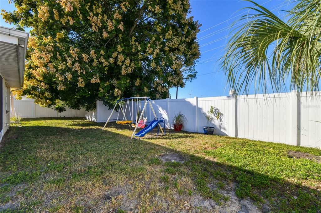 5831 1st Avenue New Port Richey, FL 34652 - Photo 22 of 22 a view of a backyard with a small cabin and a chair