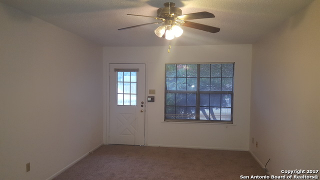 320 Station Street, Unit 101 Converse, TX 78109 - Photo 2 of 14 an empty room with windows and fan