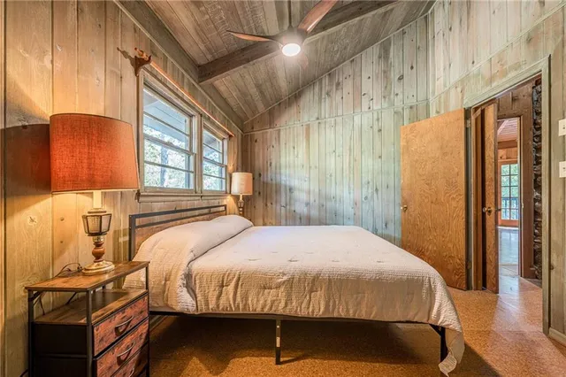 a bedroom with a bed and a lamp