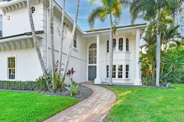 a kitchen with stainless steel appliances kitchen island granite countertop a table chairs in it and wooden floors