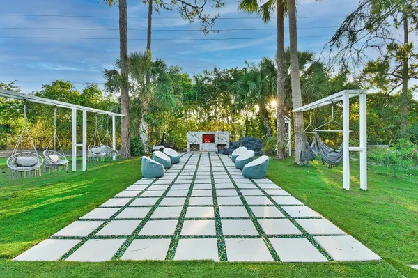 a view of a porch with furniture and a yard