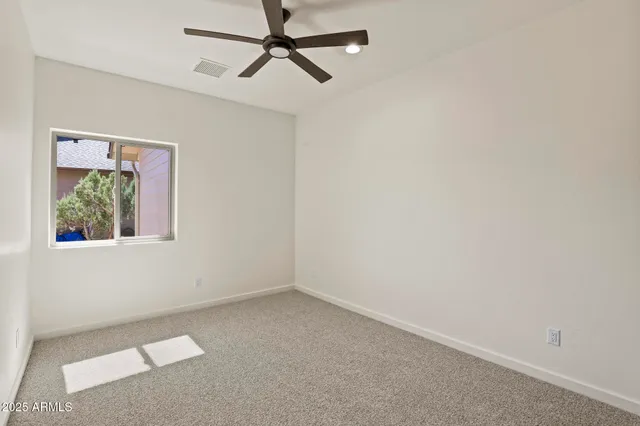 a view of room with window and ceiling fan