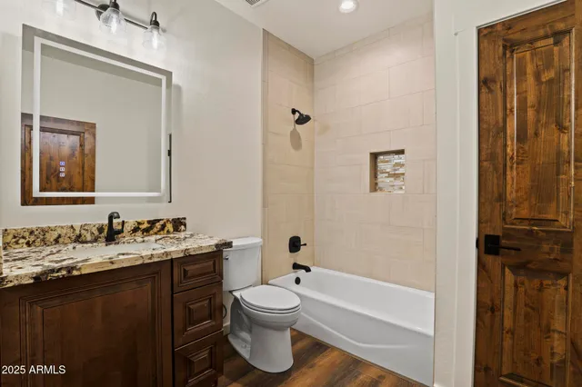 a bathroom with a toilet sink and mirror