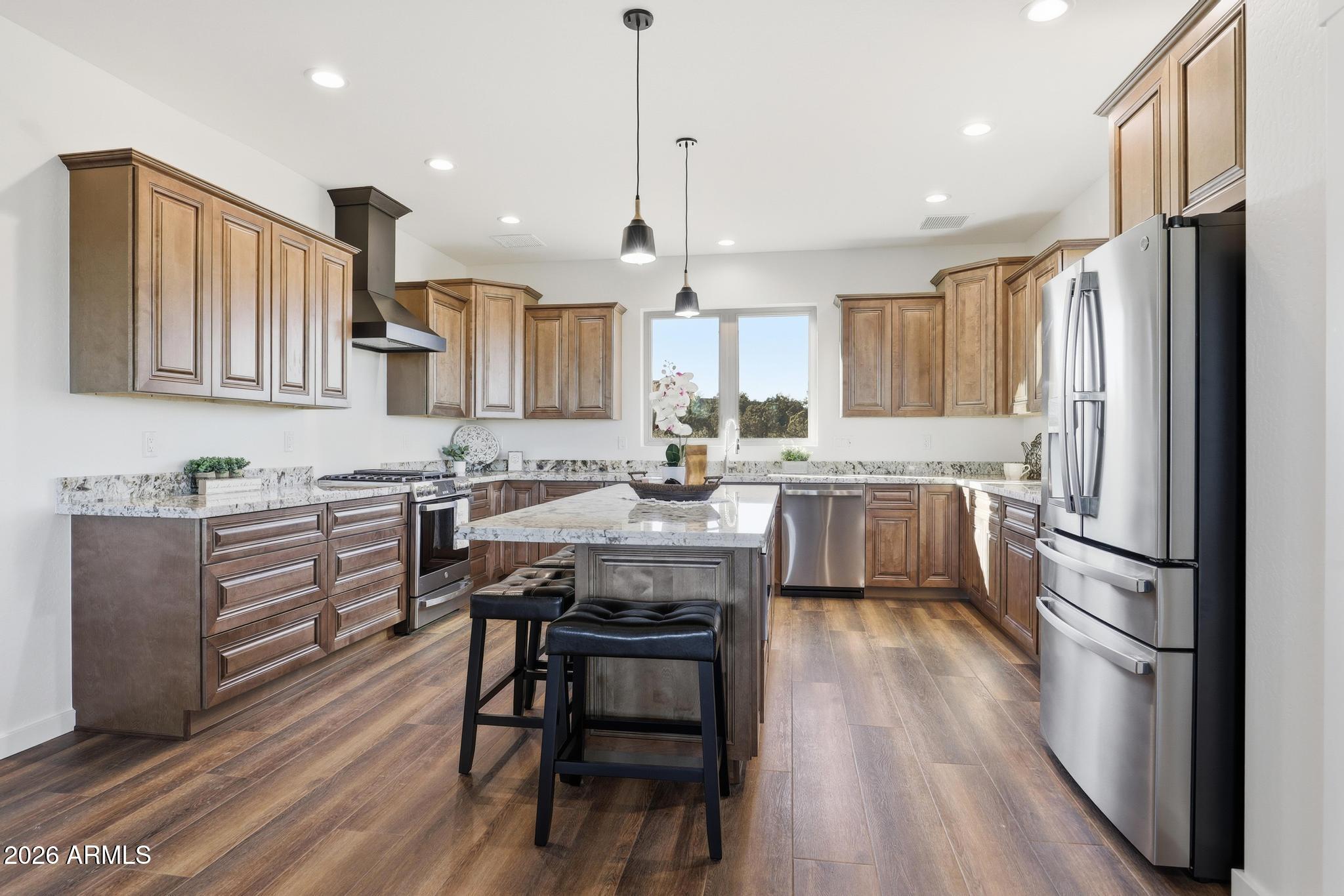 1105 South Kinzer Court Payson, AZ 85541 - Photo 16 of 44 a kitchen with a refrigerator a sink and wooden floor