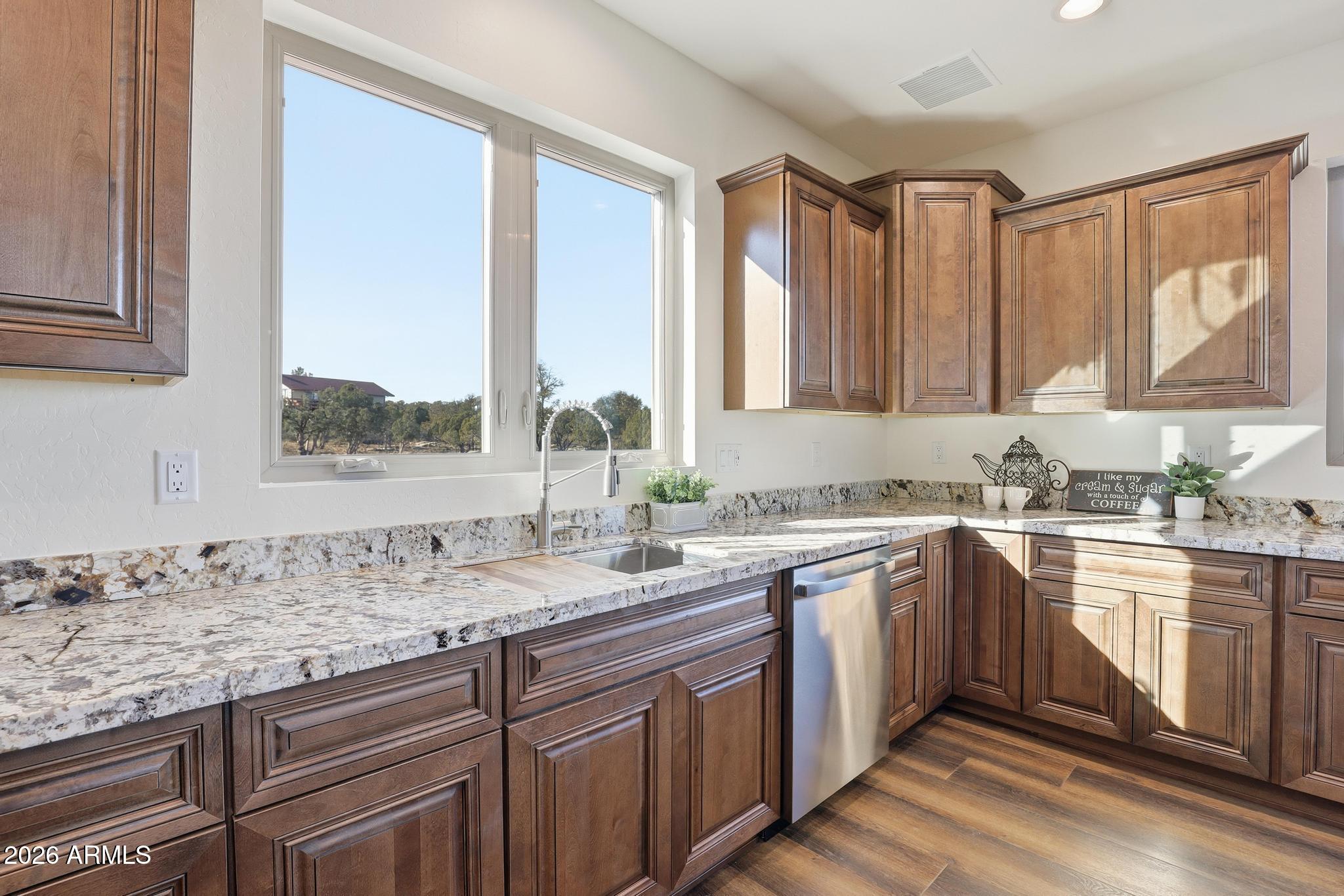 1105 South Kinzer Court Payson, AZ 85541 - Photo 18 of 44 a kitchen with stainless steel appliances granite countertop a sink stove and cabinets