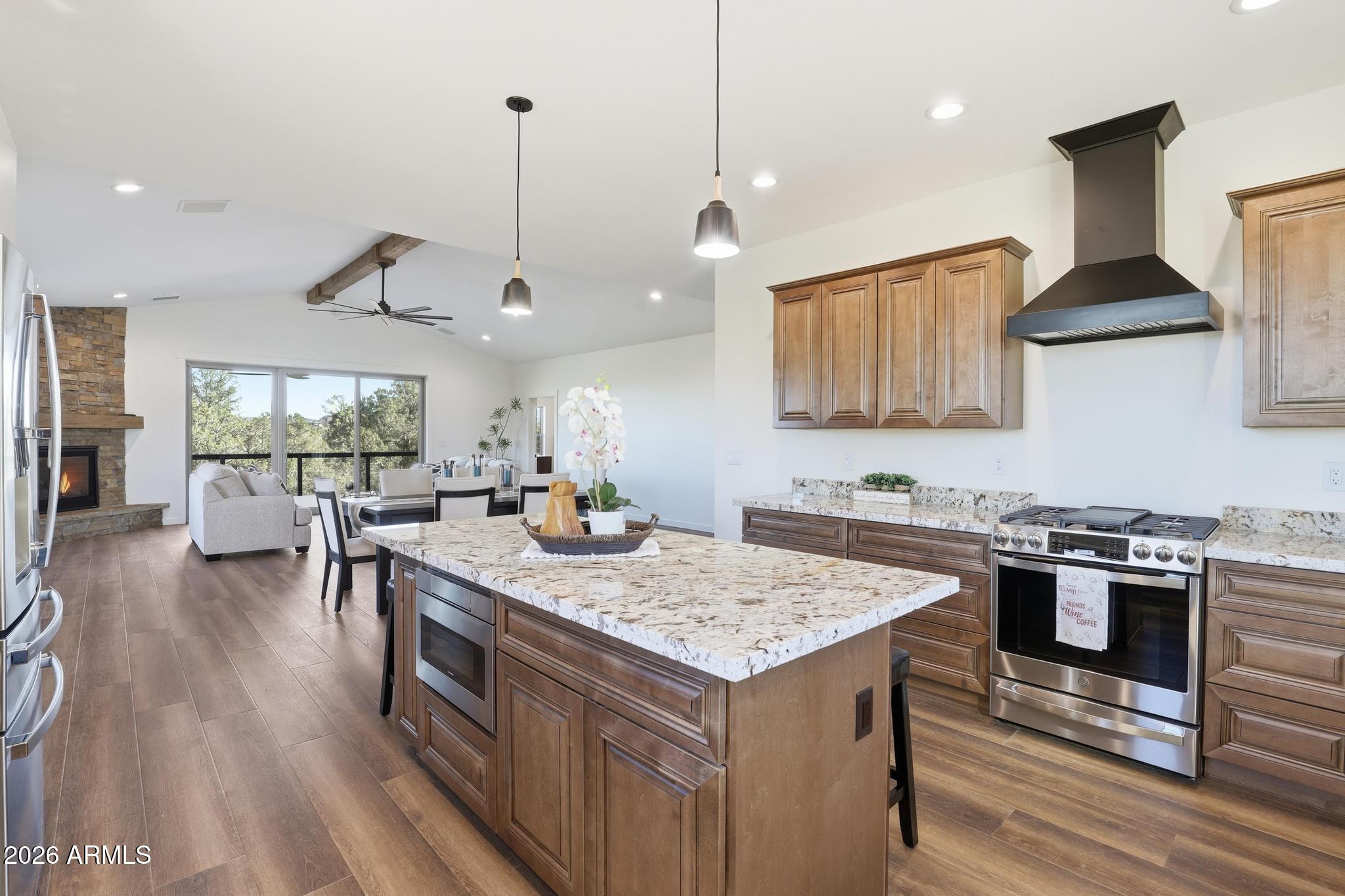 1105 South Kinzer Court Payson, AZ 85541 - Photo 19 of 44 a kitchen with a stove a oven a dining table and chairs with wooden floor
