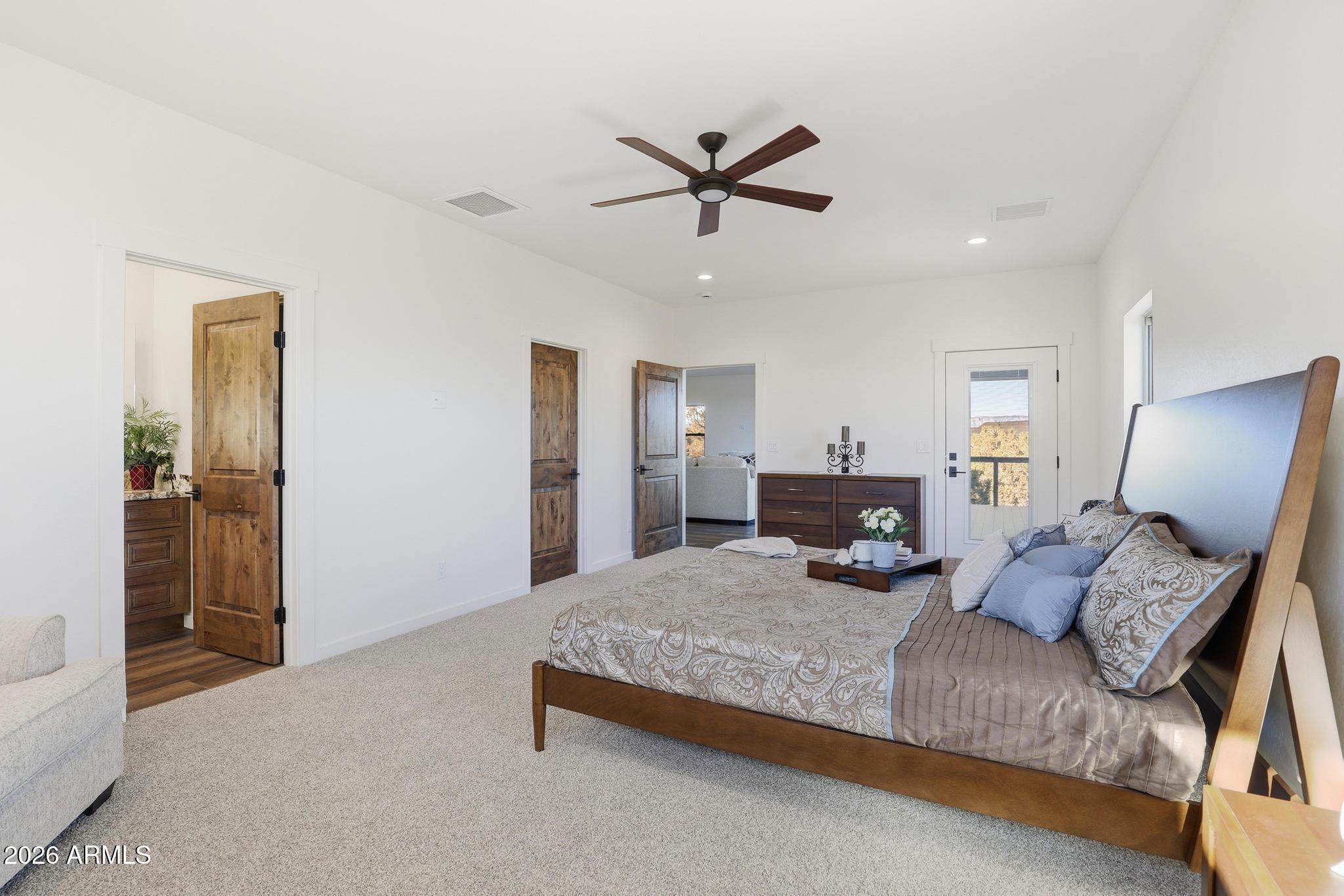 1105 South Kinzer Court Payson, AZ 85541 - Photo 21 of 44 a bedroom with a bed and ceiling fan