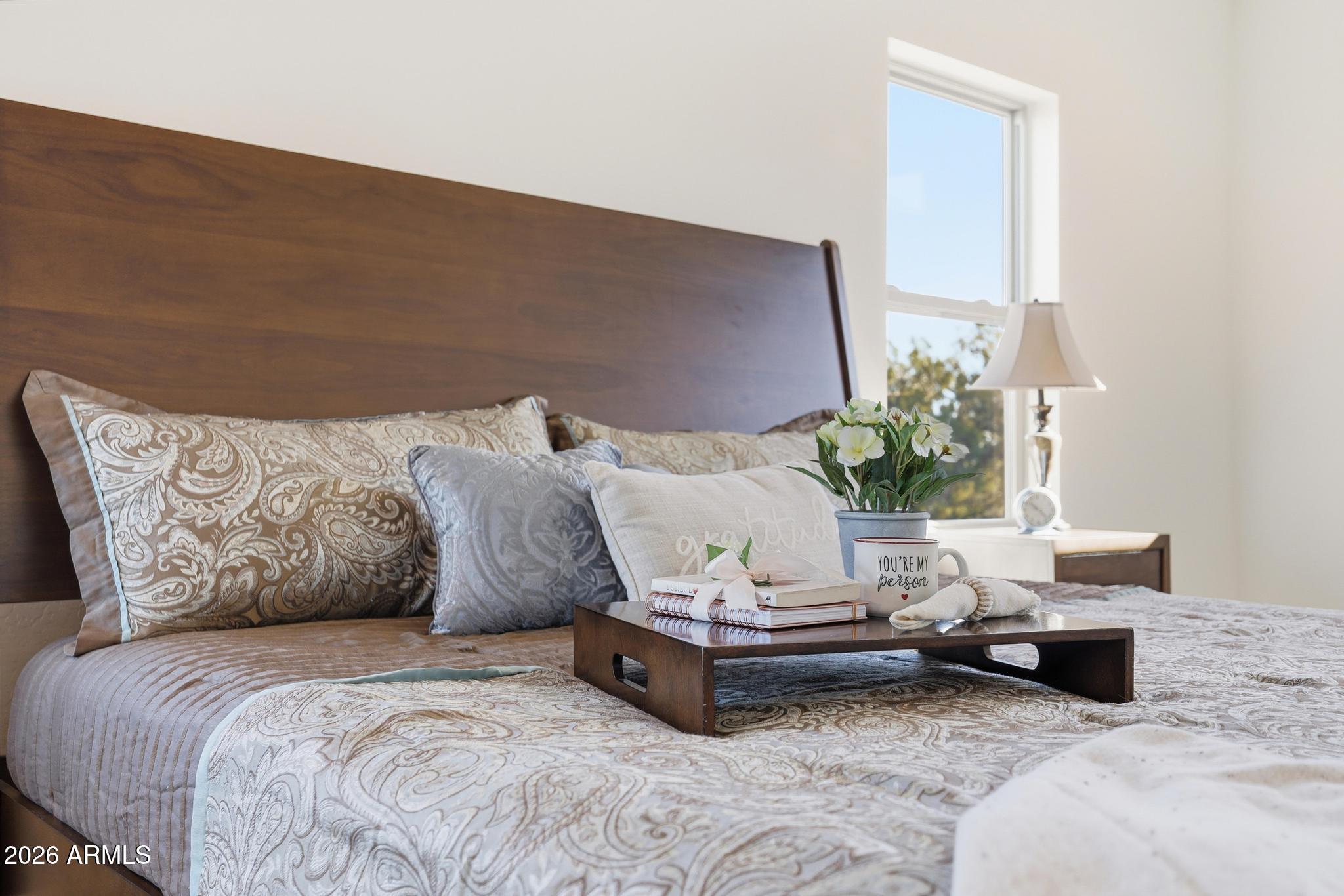 1105 South Kinzer Court Payson, AZ 85541 - Photo 22 of 44 a bed sitting in a bedroom next to a lamp