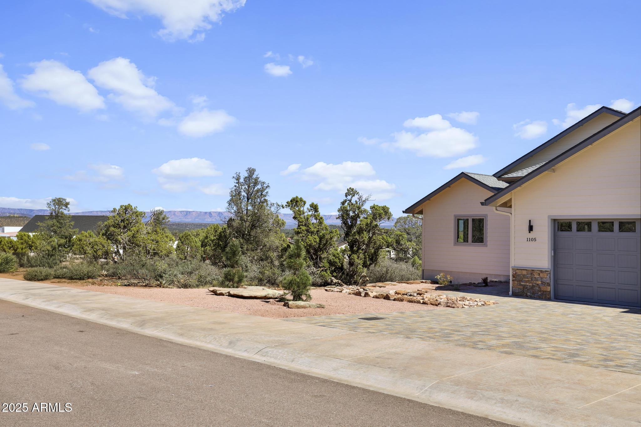 1105 South Kinzer Court Payson, AZ 85541 - Photo 40 of 44 a view of a house with a snow on the road and a building