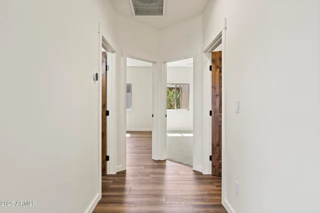 a view of a hallway with wooden floor
