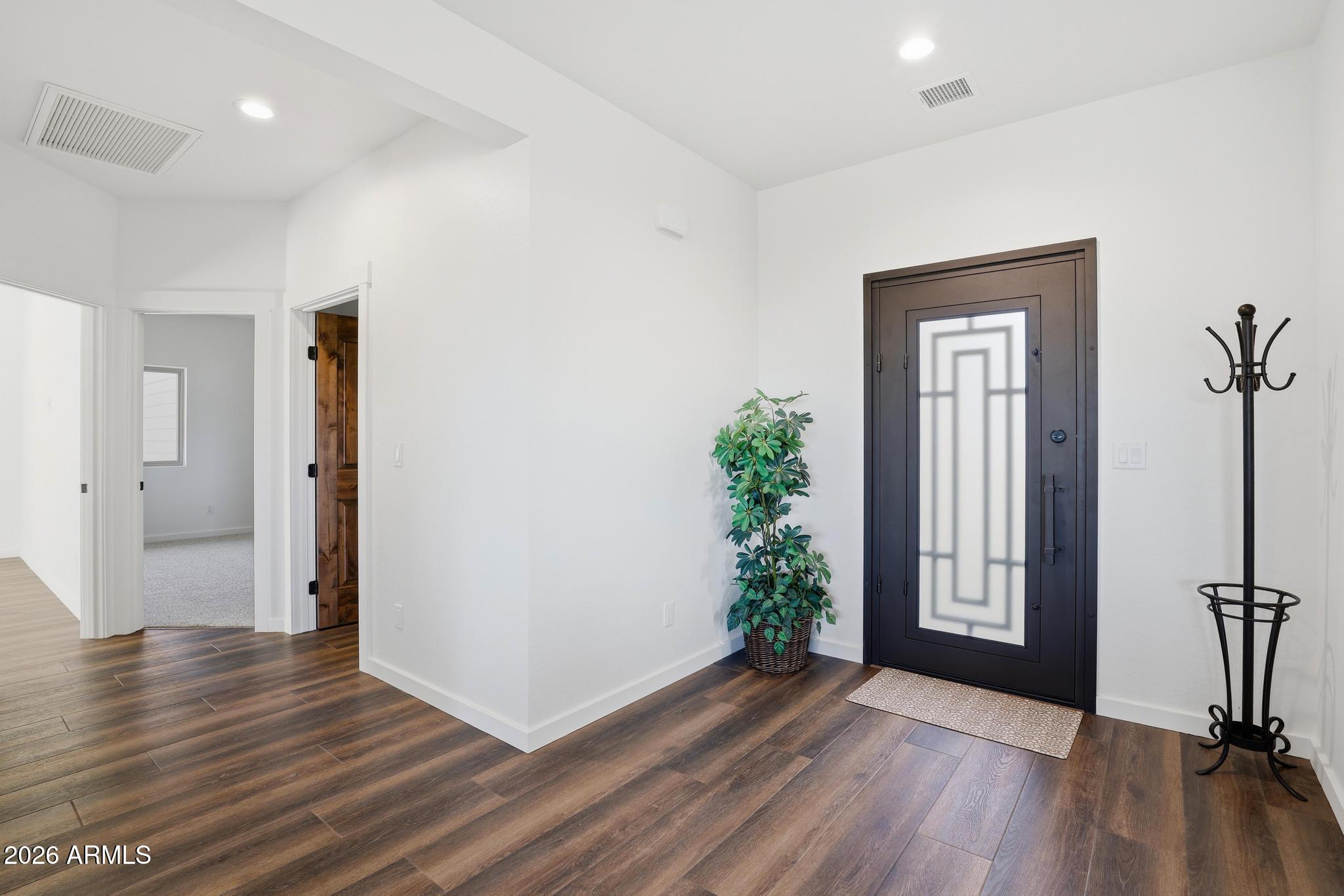 1105 South Kinzer Court Payson, AZ 85541 - Photo 9 of 44 an empty room with wooden floor and windows