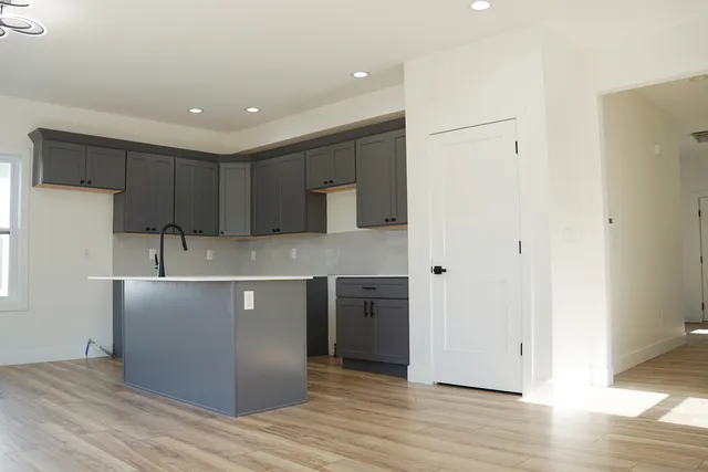 a kitchen with stainless steel appliances granite countertop a sink a stove a refrigerator and cabinets