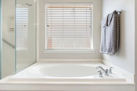a bathroom with a bathtub and a shower