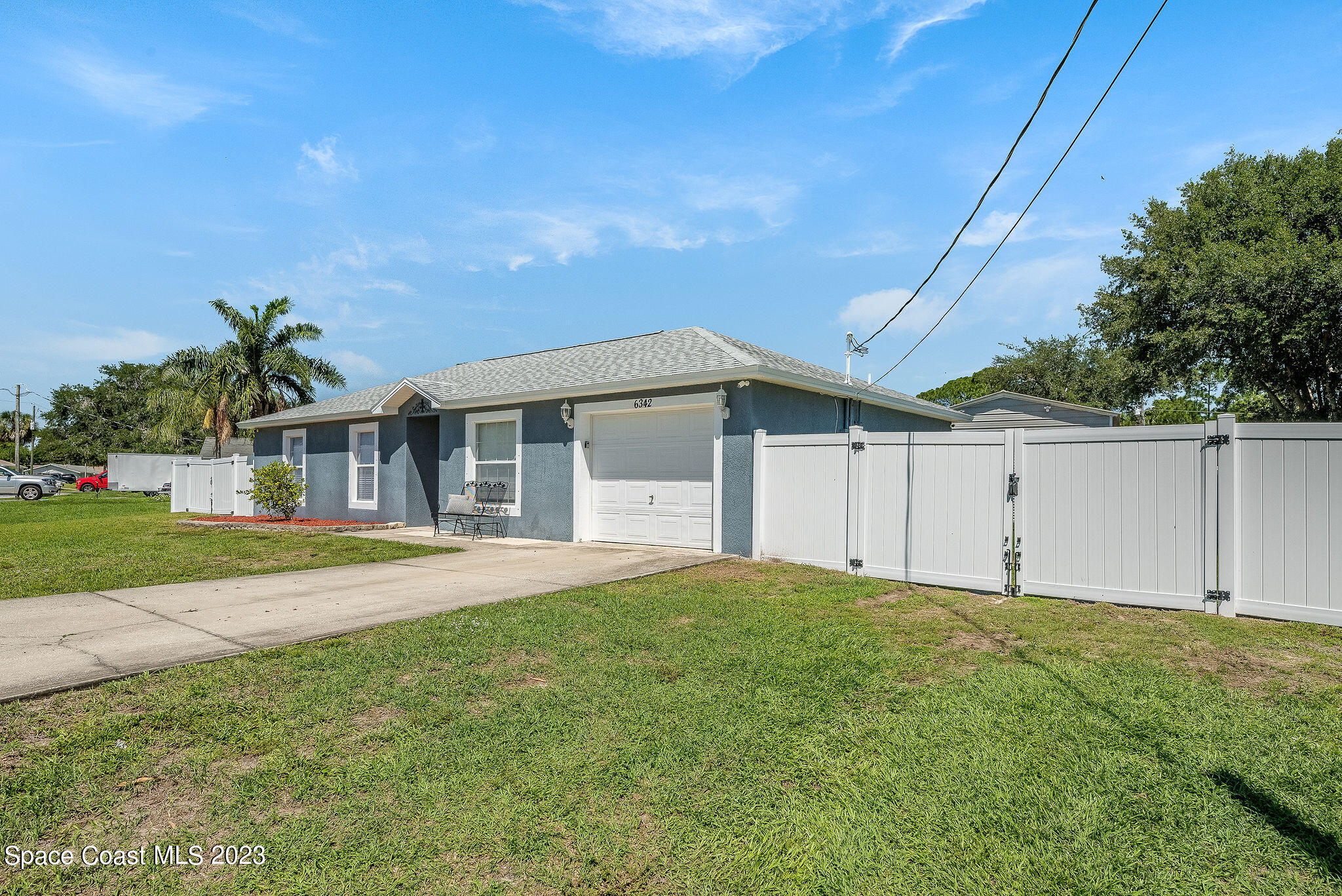6342 Hudson Road Cocoa, FL 32927 - Photo 19 of 30 a front view of a house with a yard and garage