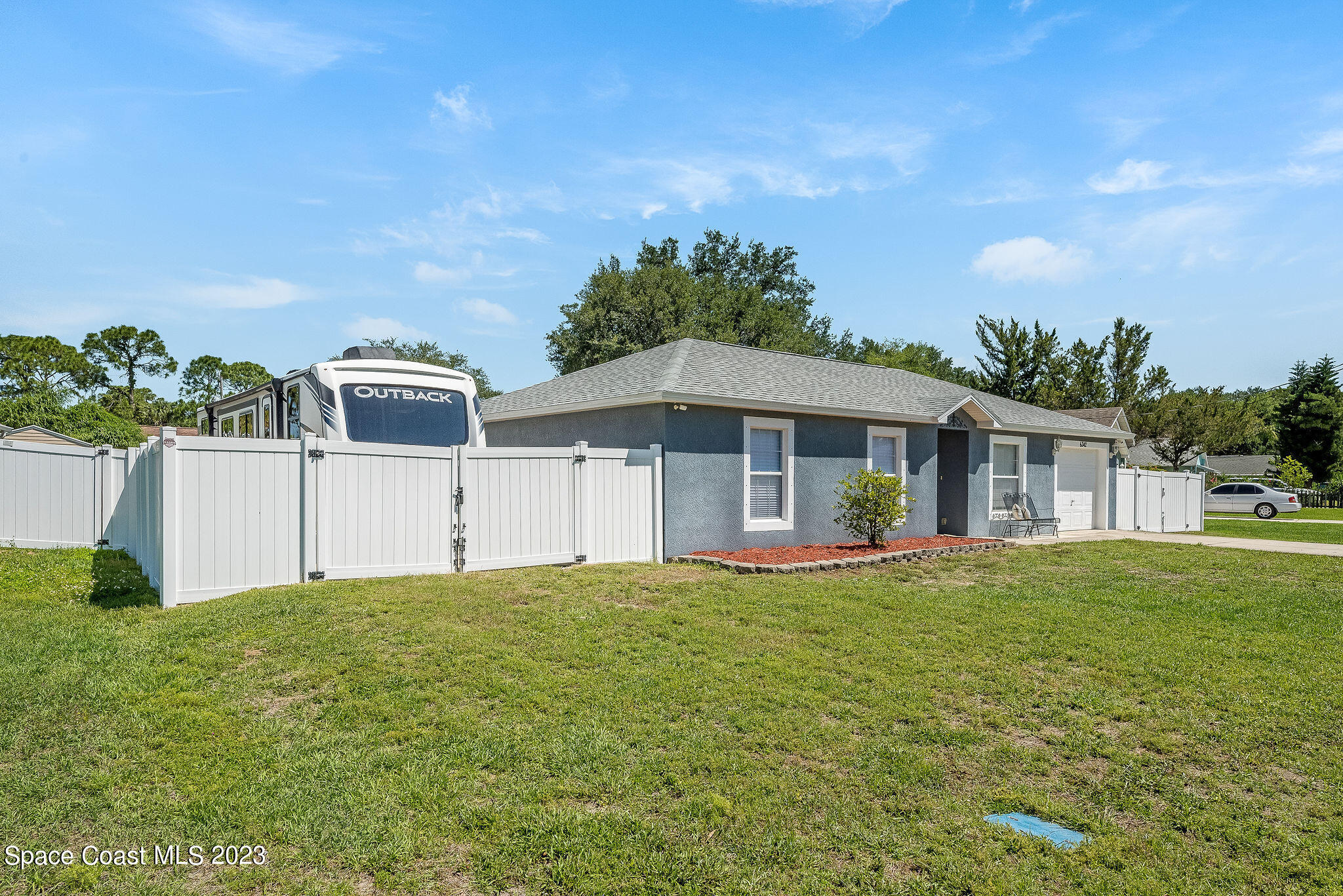 6342 Hudson Road Cocoa, FL 32927 - Photo 20 of 30 a front view of a house with a yard and garage