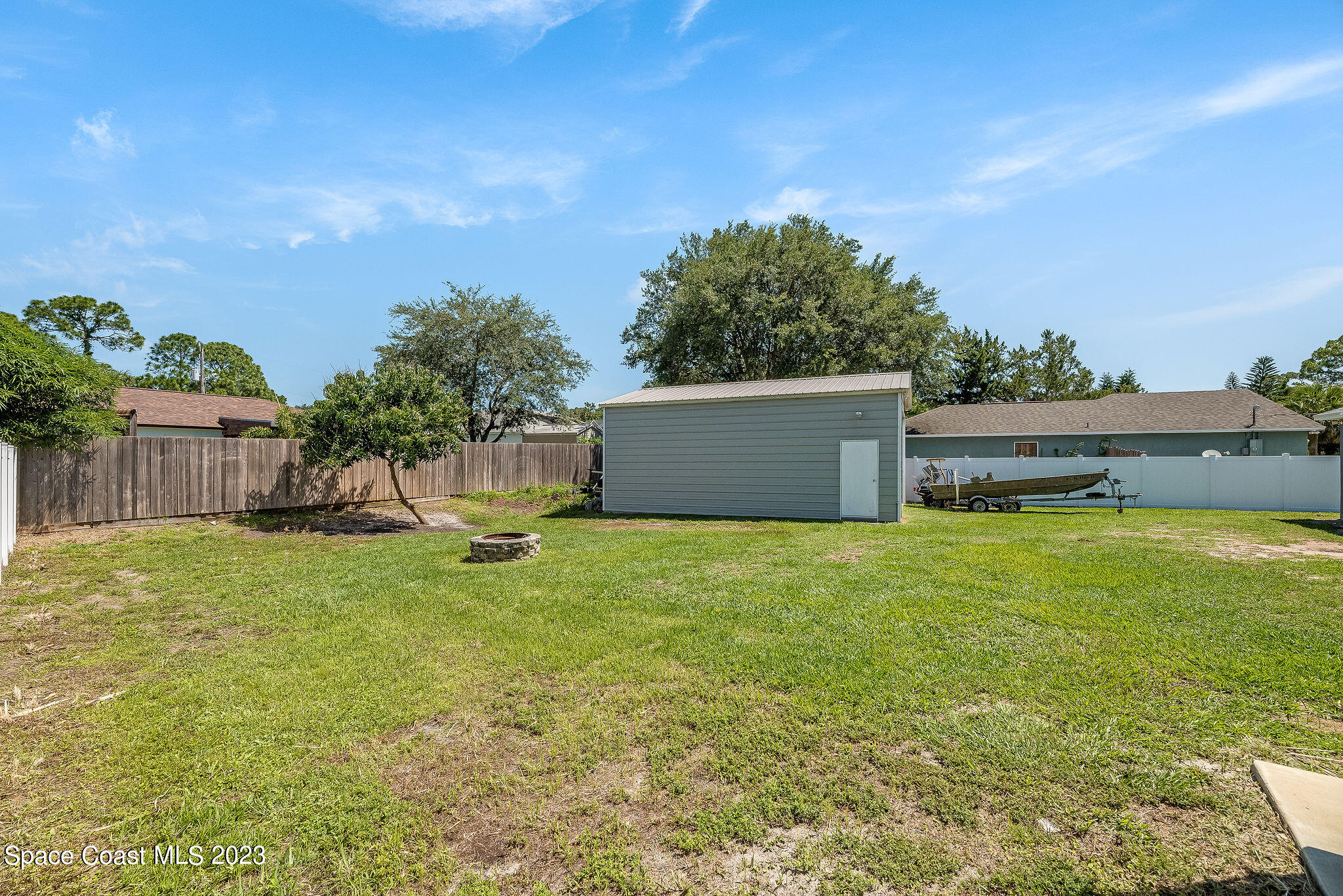 6342 Hudson Road Cocoa, FL 32927 - Photo 23 of 30 a backyard of a house with a garden and deck