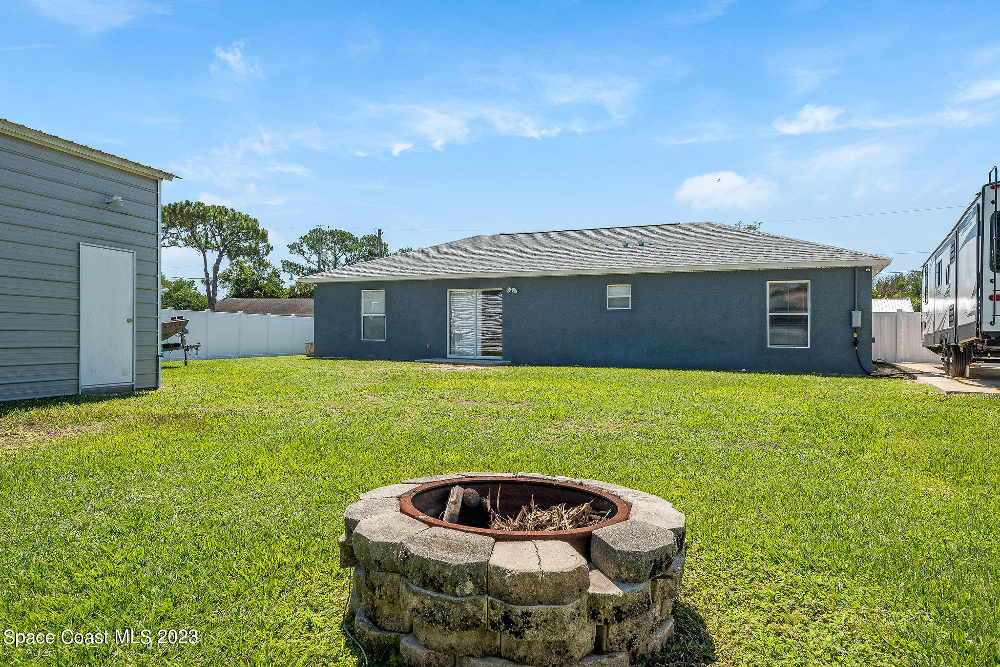 6342 Hudson Road Cocoa, FL 32927 - Photo 25 of 30 a front view of a house with a garden and yard