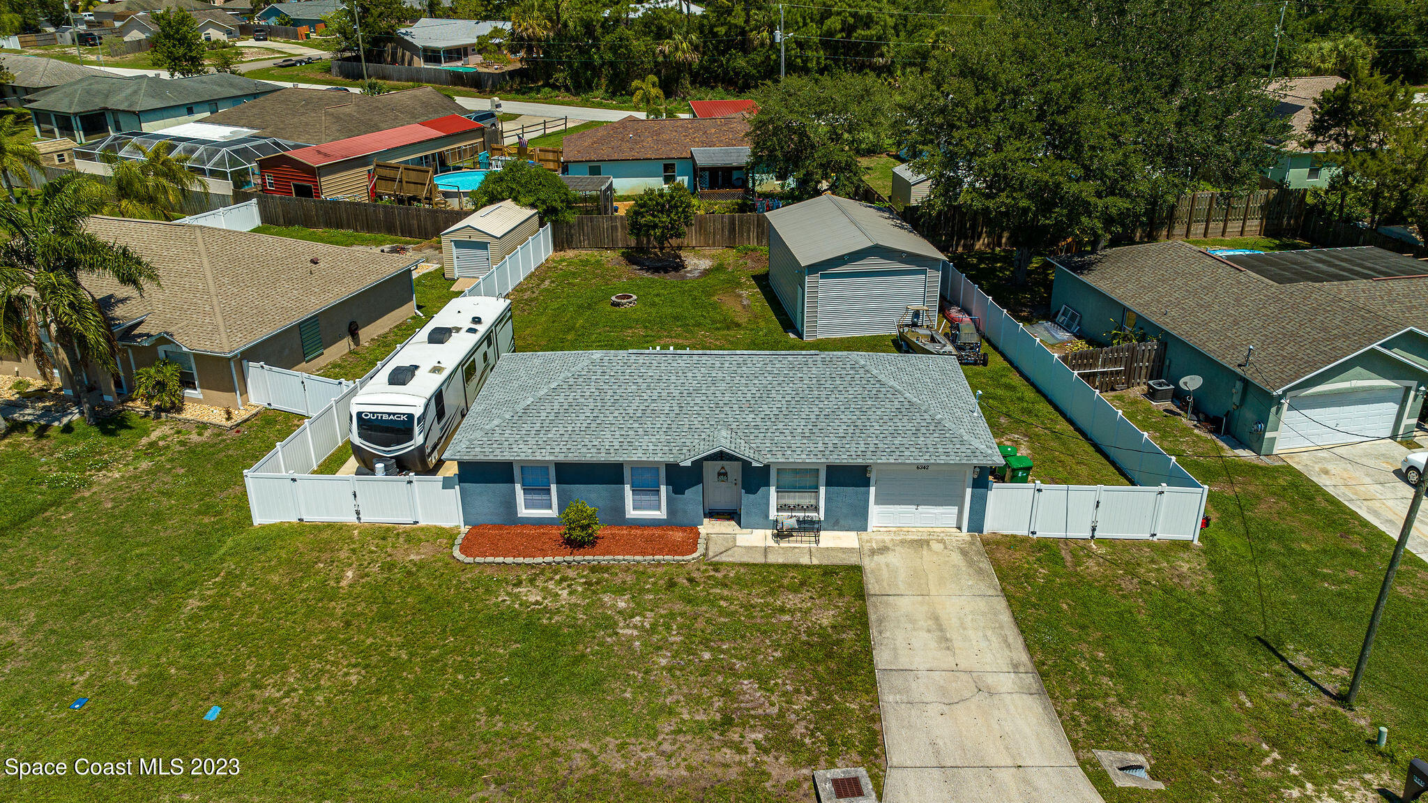 6342 Hudson Road Cocoa, FL 32927 - Photo 3 of 30 a aerial view of a house with swimming pool and large trees