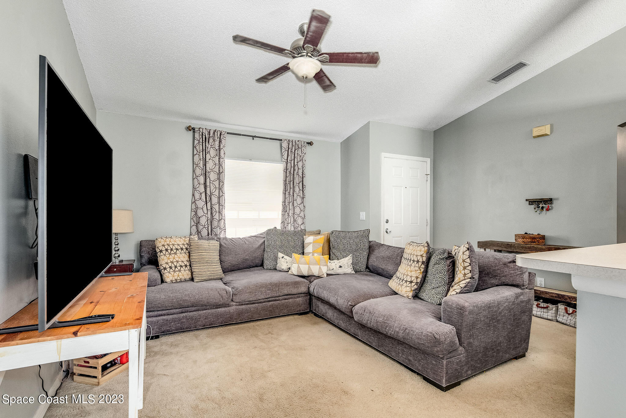 6342 Hudson Road Cocoa, FL 32927 - Photo 5 of 30 a living room with furniture and a flat screen tv