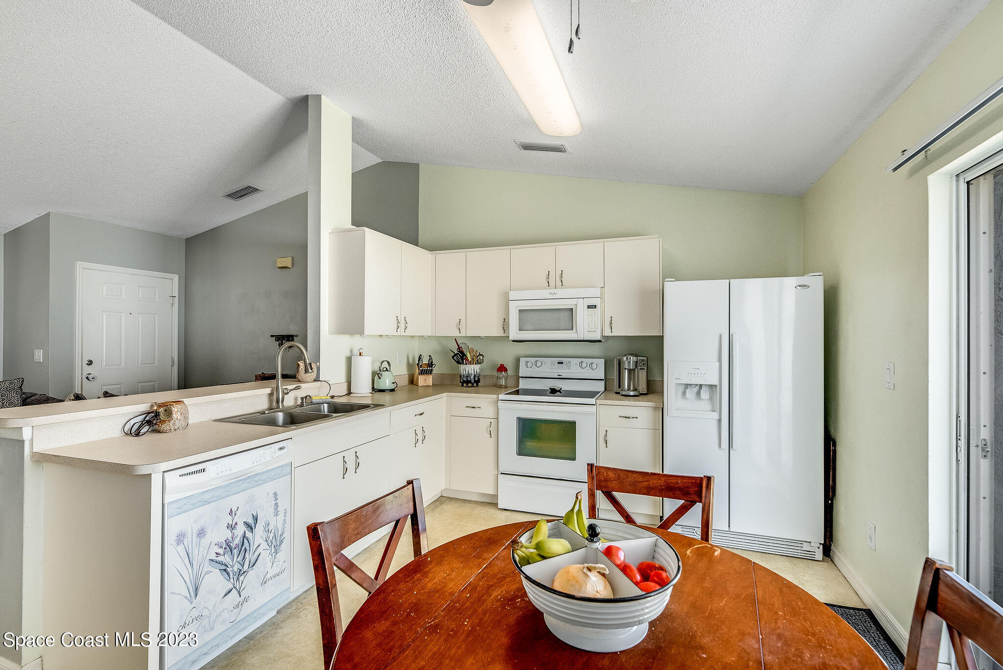 6342 Hudson Road Cocoa, FL 32927 - Photo 8 of 30 a open kitchen with stainless steel appliances kitchen island granite countertop a sink stove and refrigerator