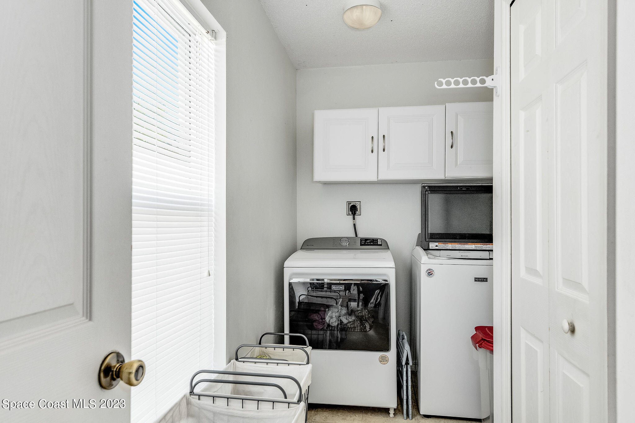 6342 Hudson Road Cocoa, FL 32927 - Photo 10 of 30 a kitchen with a stove and white cabinets