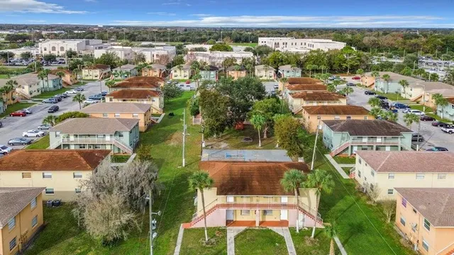 an aerial view of residential houses with outdoor space and street view