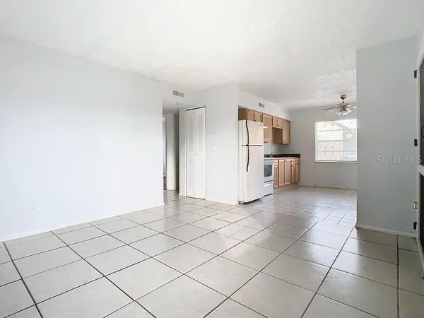 a view of a kitchen with a sink and a refrigerator