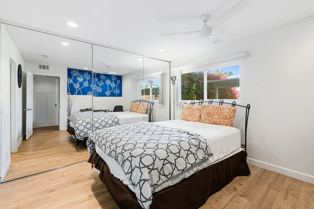 a bed room with a bed mirror and a window