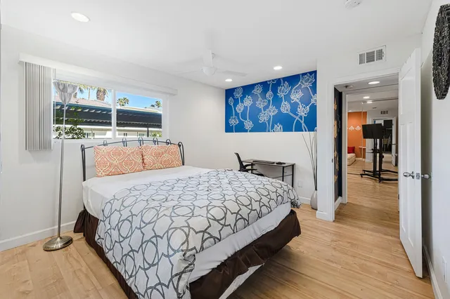 a bedroom with a large bed and a window