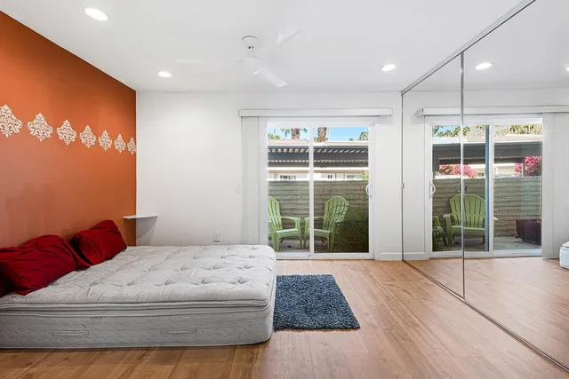 a bedroom with a large bed and a large window