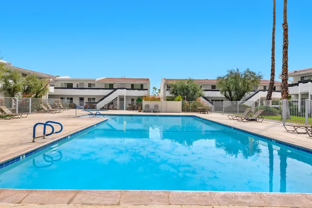 a view of a swimming pool with a lounge chair