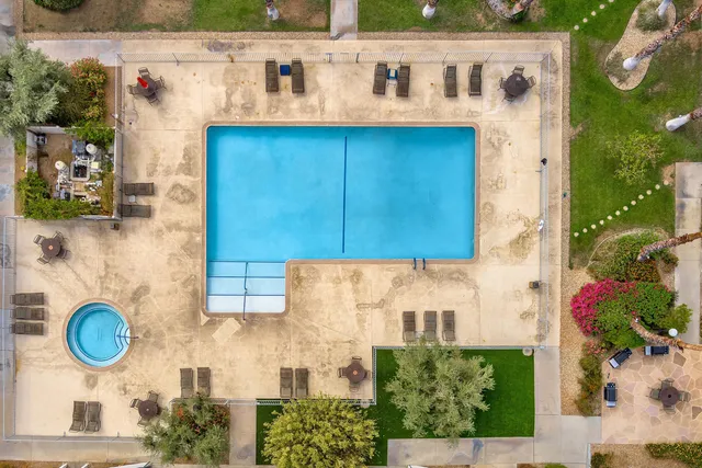 a view of swimming pool with a lounge chairs