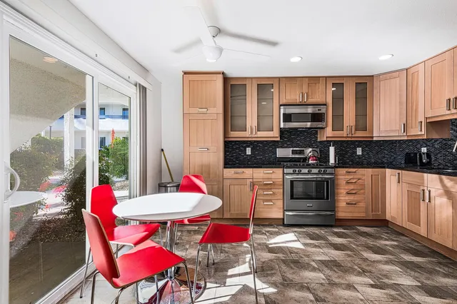 a kitchen with stainless steel appliances kitchen island granite countertop a sink and cabinets