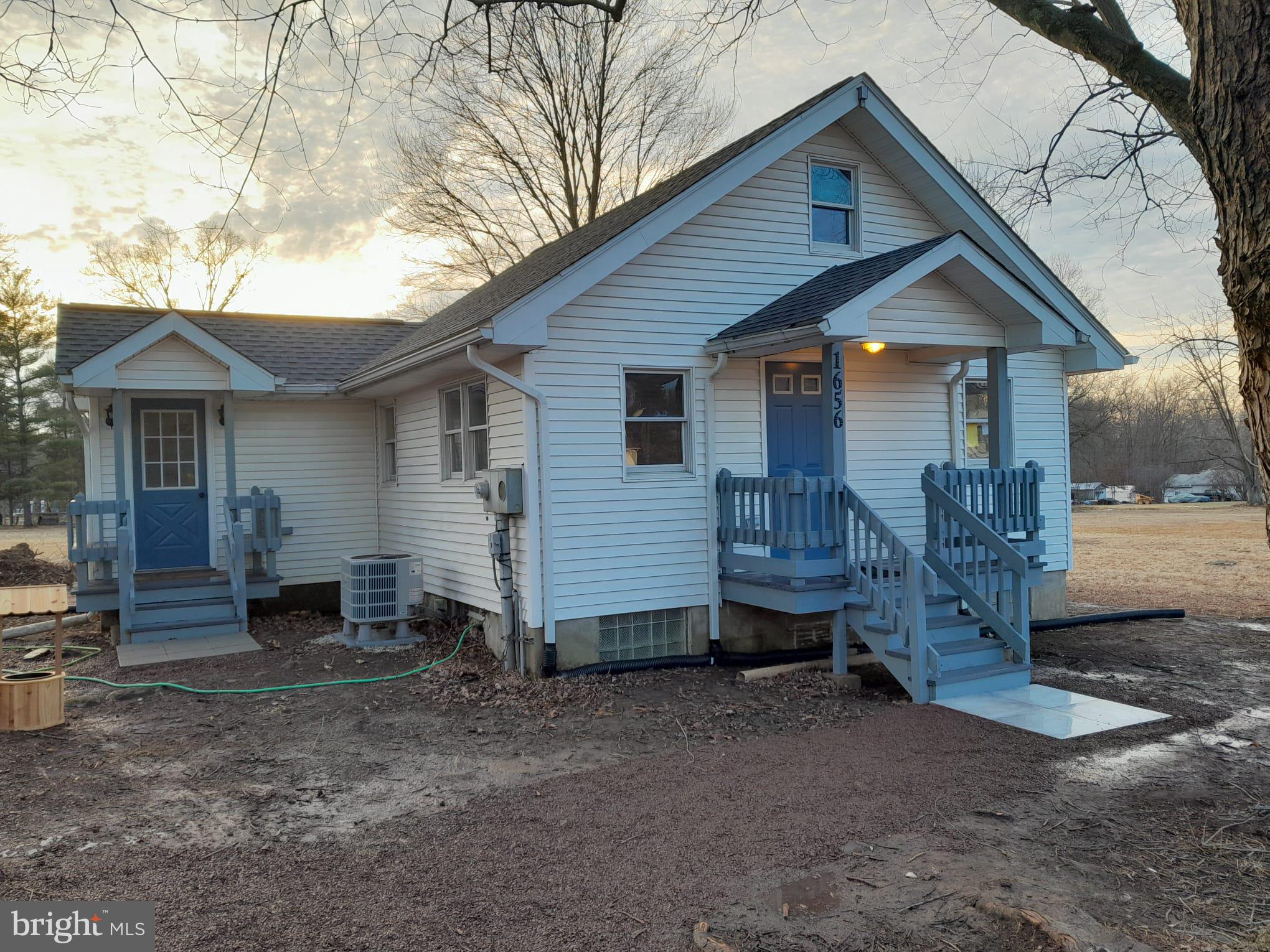 1656 Chestnut Ridge Road Upper Black Eddy, PA 18972 - Photo 1 of 32 a view of a house with a yard and wooden fence