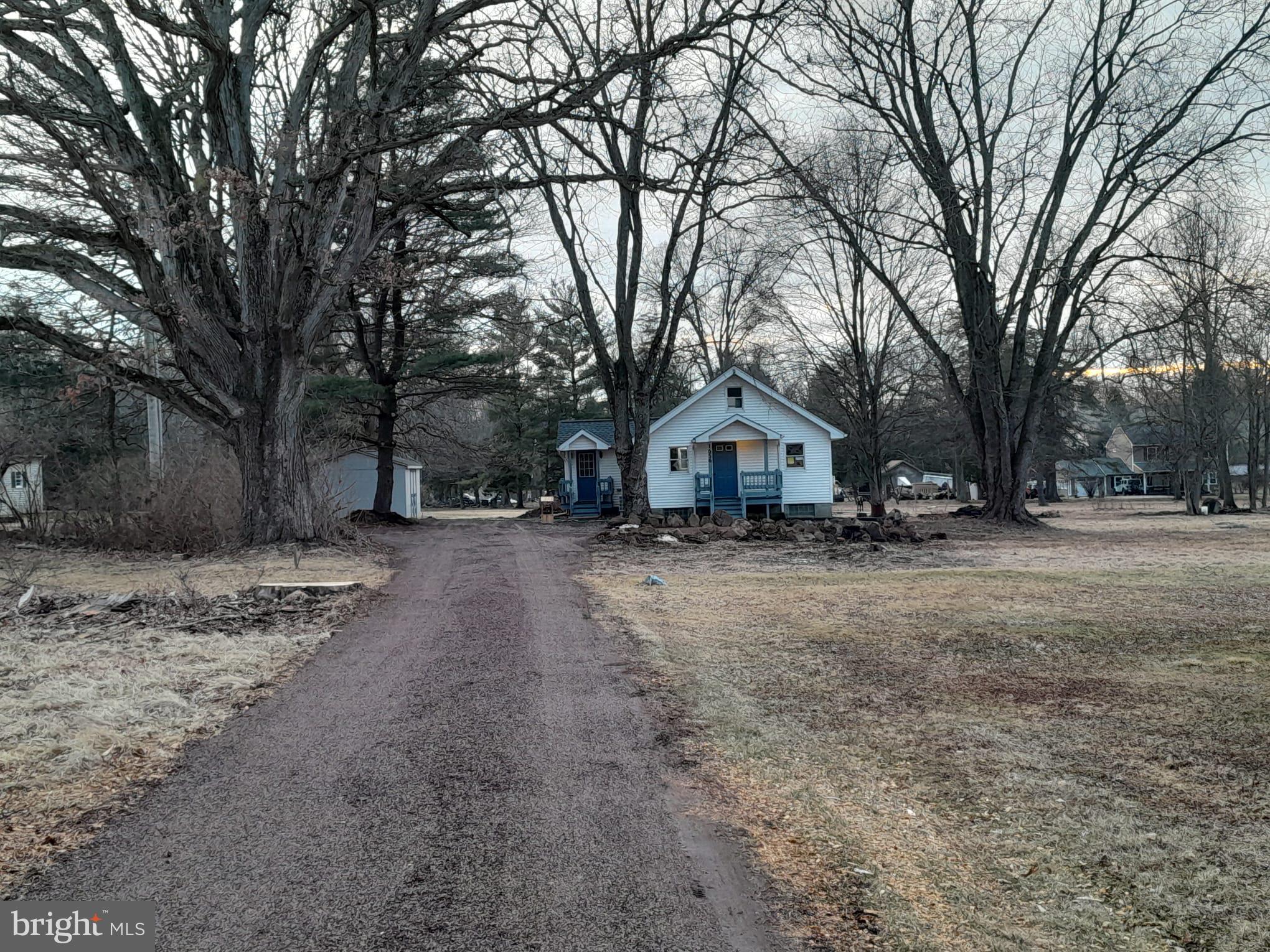 1656 Chestnut Ridge Road Upper Black Eddy, PA 18972 - Photo 4 of 32 a front view of house with trees and wooden fence