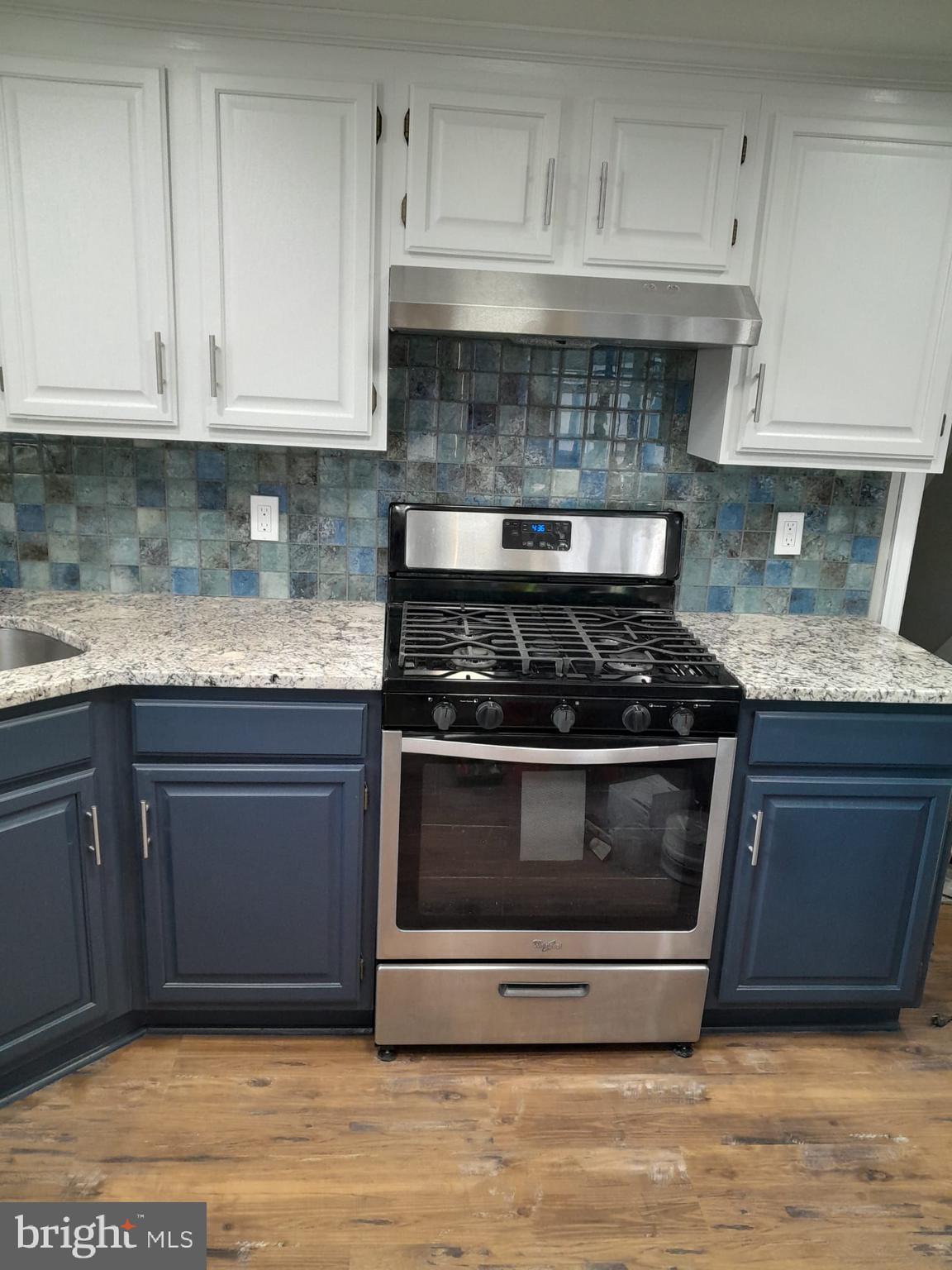 1656 Chestnut Ridge Road Upper Black Eddy, PA 18972 - Photo 9 of 32 a kitchen with granite countertop stainless steel appliances and white cabinets