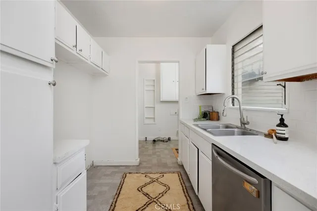 a kitchen with a sink cabinets and appliances