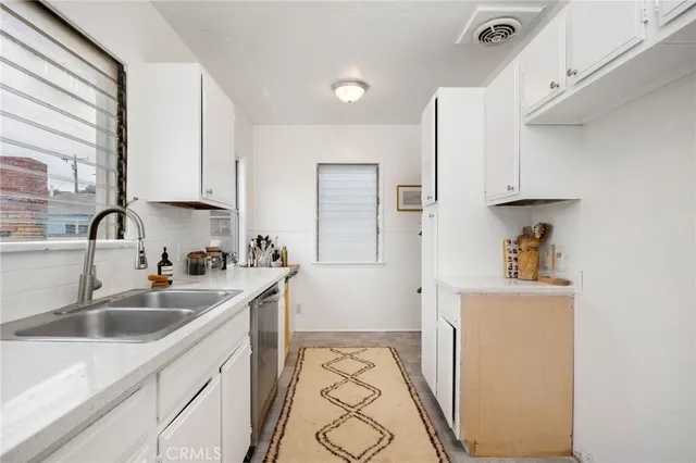 a kitchen with a sink stove and refrigerator