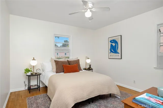 a bedroom with bed and wooden floor