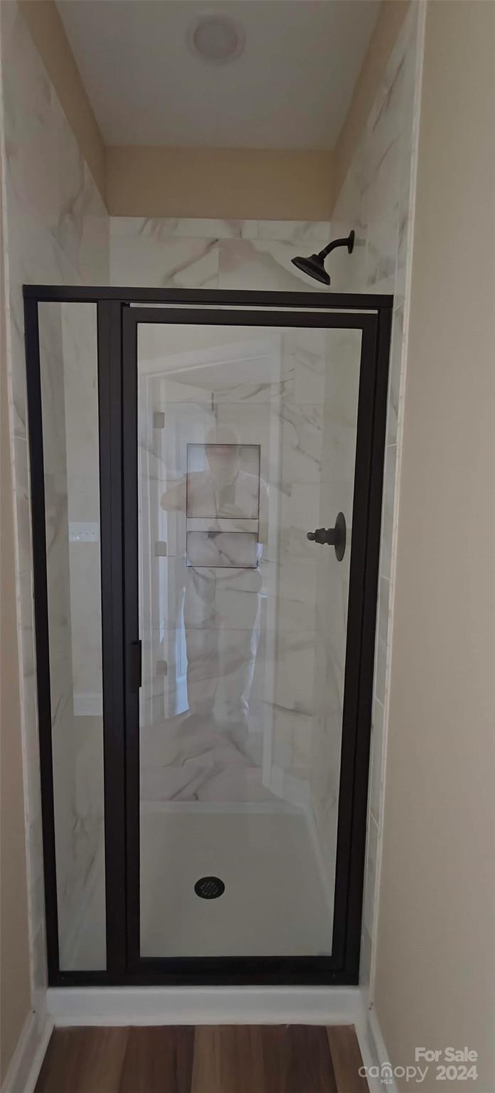 9649 Stokes Ferry Road Gold Hill, NC 28071 - Photo 13 of 17 a bathroom with a glass shower door
