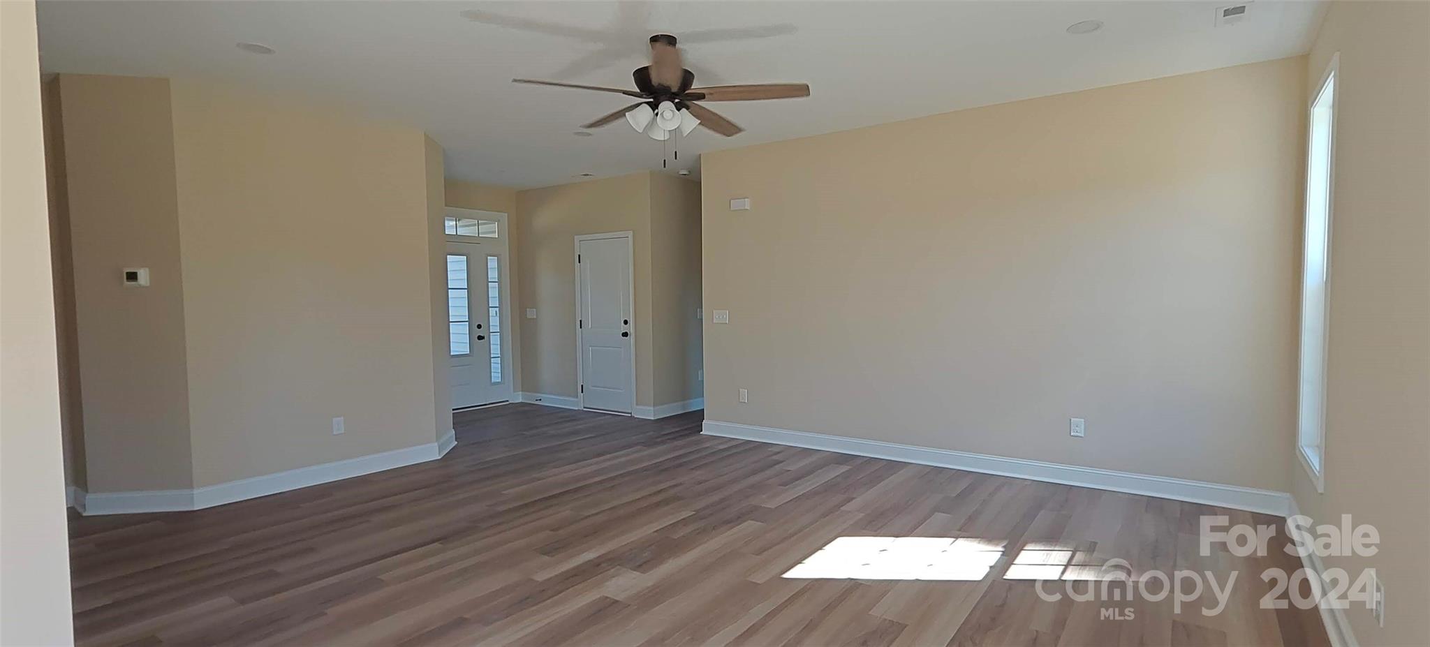 9649 Stokes Ferry Road Gold Hill, NC 28071 - Photo 17 of 17 wooden floor in an empty room with a window