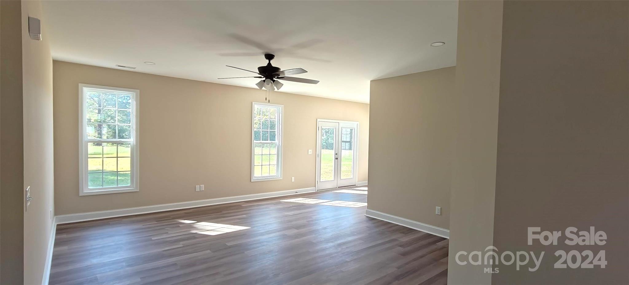 9649 Stokes Ferry Road Gold Hill, NC 28071 - Photo 3 of 17 a view of an empty room with a window and wooden floor