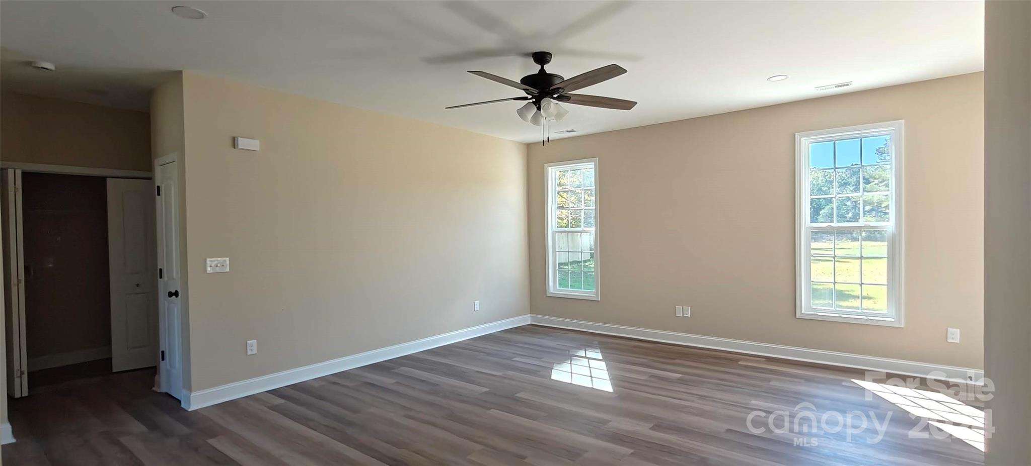 9649 Stokes Ferry Road Gold Hill, NC 28071 - Photo 7 of 17 a view of empty room with wooden floor and fan