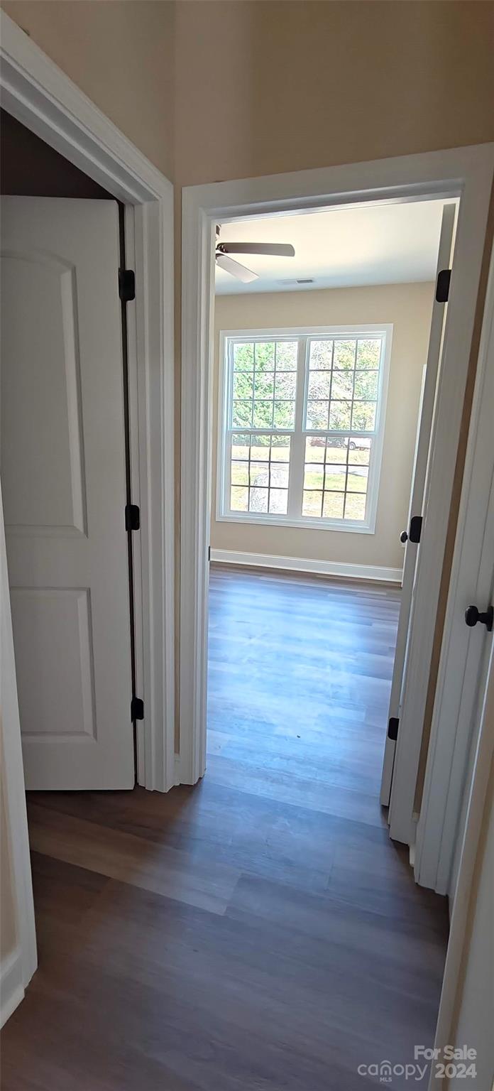 9649 Stokes Ferry Road Gold Hill, NC 28071 - Photo 8 of 17 an empty room with wooden floor and windows