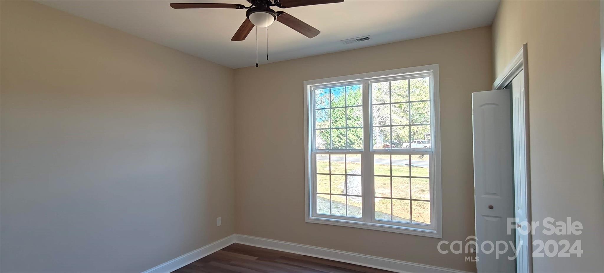 9649 Stokes Ferry Road Gold Hill, NC 28071 - Photo 10 of 17 a view of a livingroom with a window and a ceiling fan