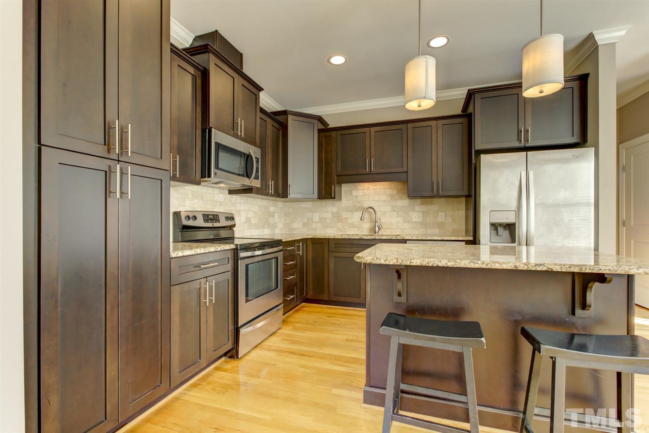 422 Heather Drive Raleigh, NC 27606 - Photo 7 of 30 Notice the SS Appliances, Granite Counters + Tile Backsplash.